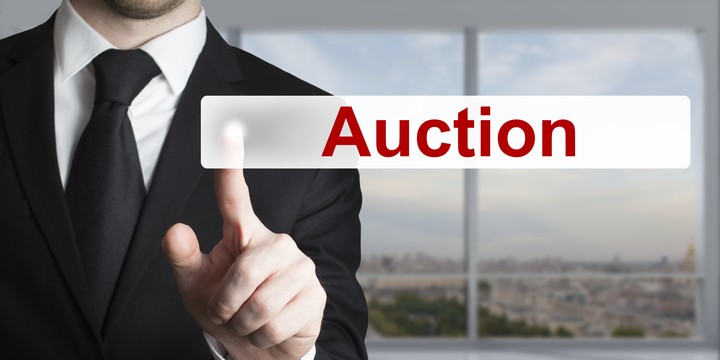 businessman pushing button auction