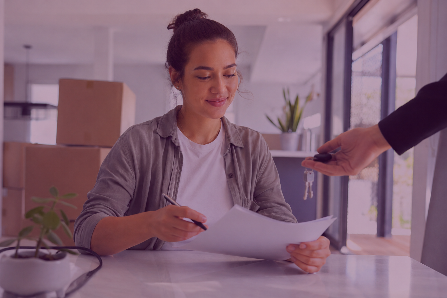 Tenant reviewing rental documents and keys in a Townsville rental property